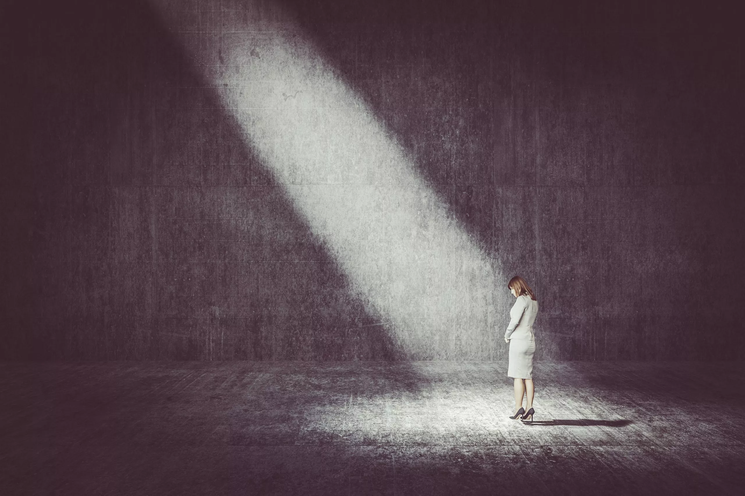 Businesswoman standing under the spotlight